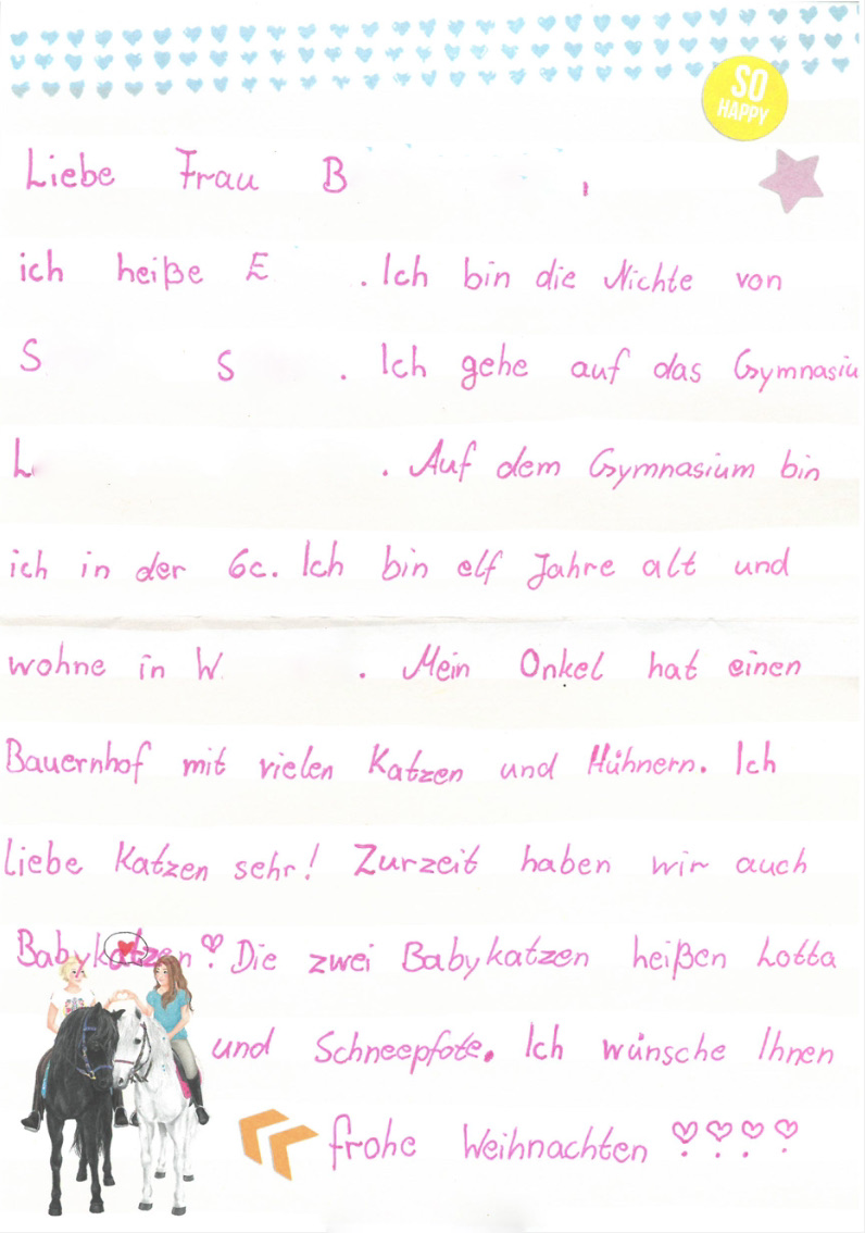 Ein handgeschriebener Brief mit kleiner Illustration liegt flach ausgebreitet.