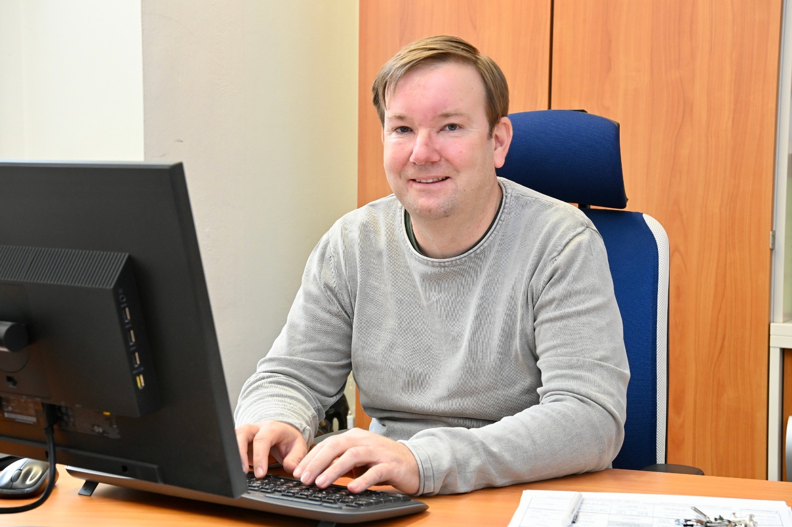 Mann am Tisch hinter Computer